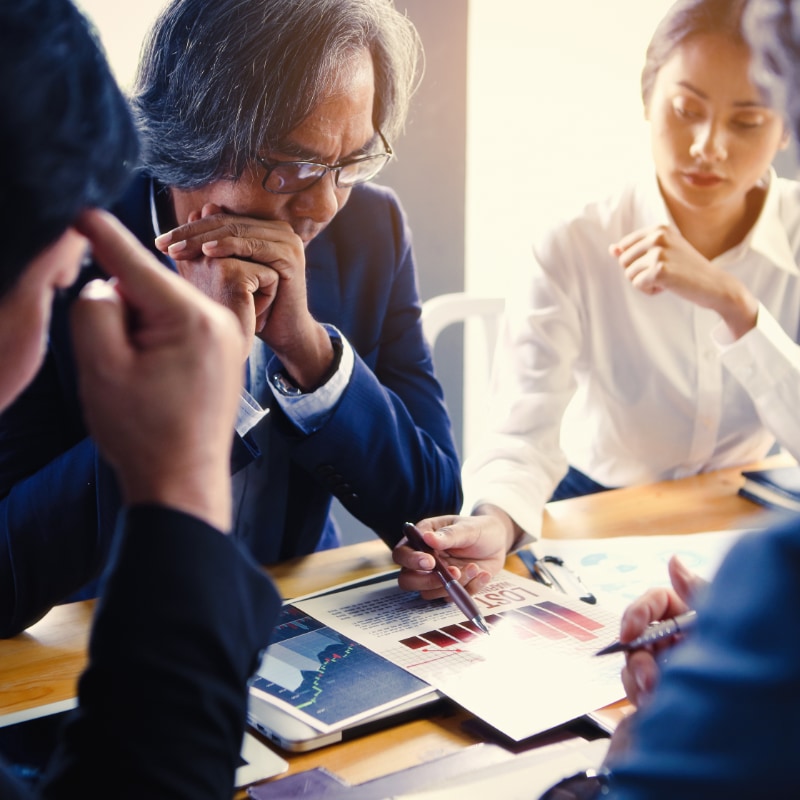 A group of business people reading a chart