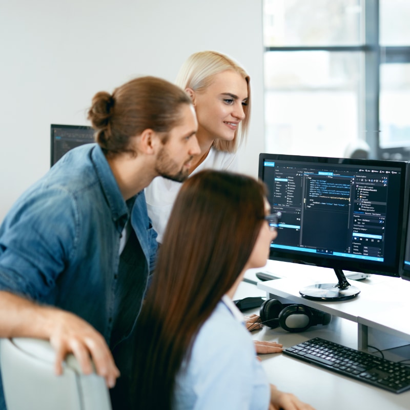 Workers looking at a computer screen