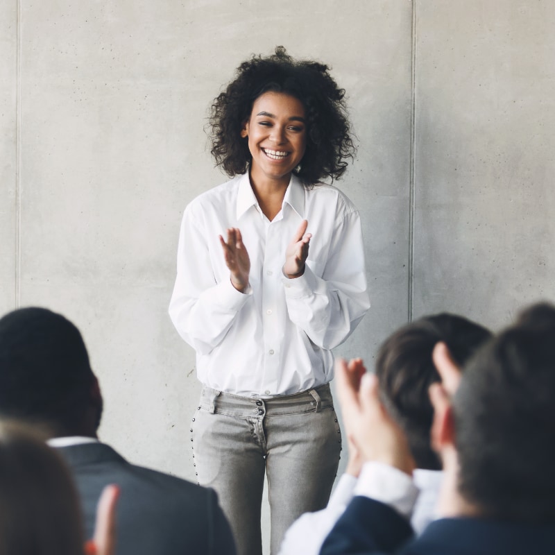A woman talking to a group of collegues