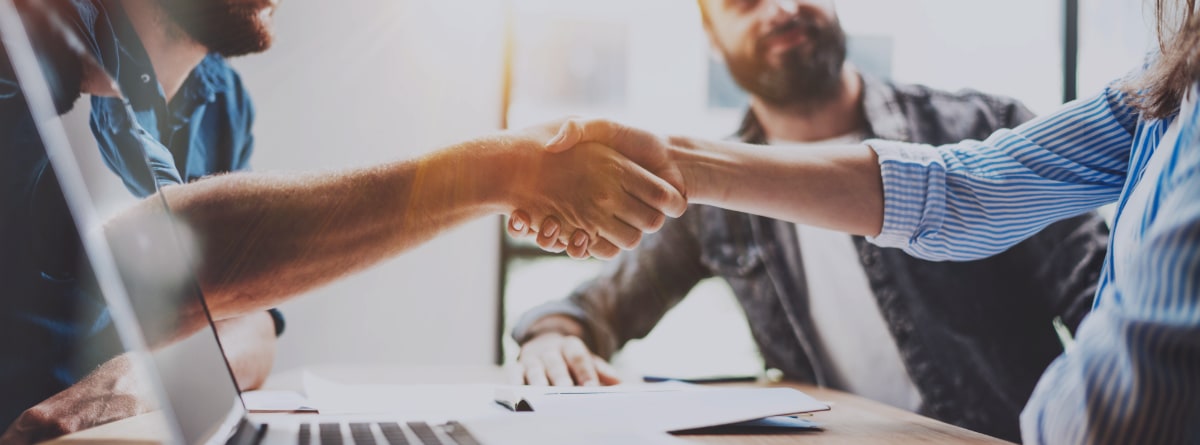 handshake across a table