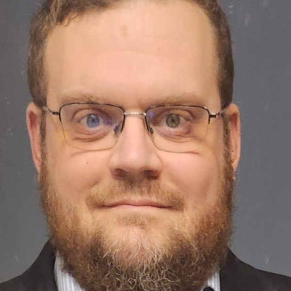 Contract Manager Jason Peters, a man with thin rimmed glasses and a beard