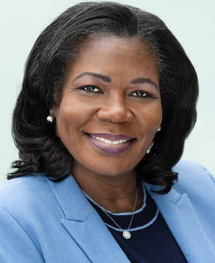 smiling woman with shoulder length black hair and a light blue suit jacket